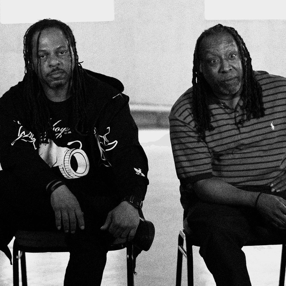Two men seated, from the documentary